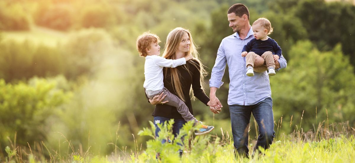 Cute family playing summer field